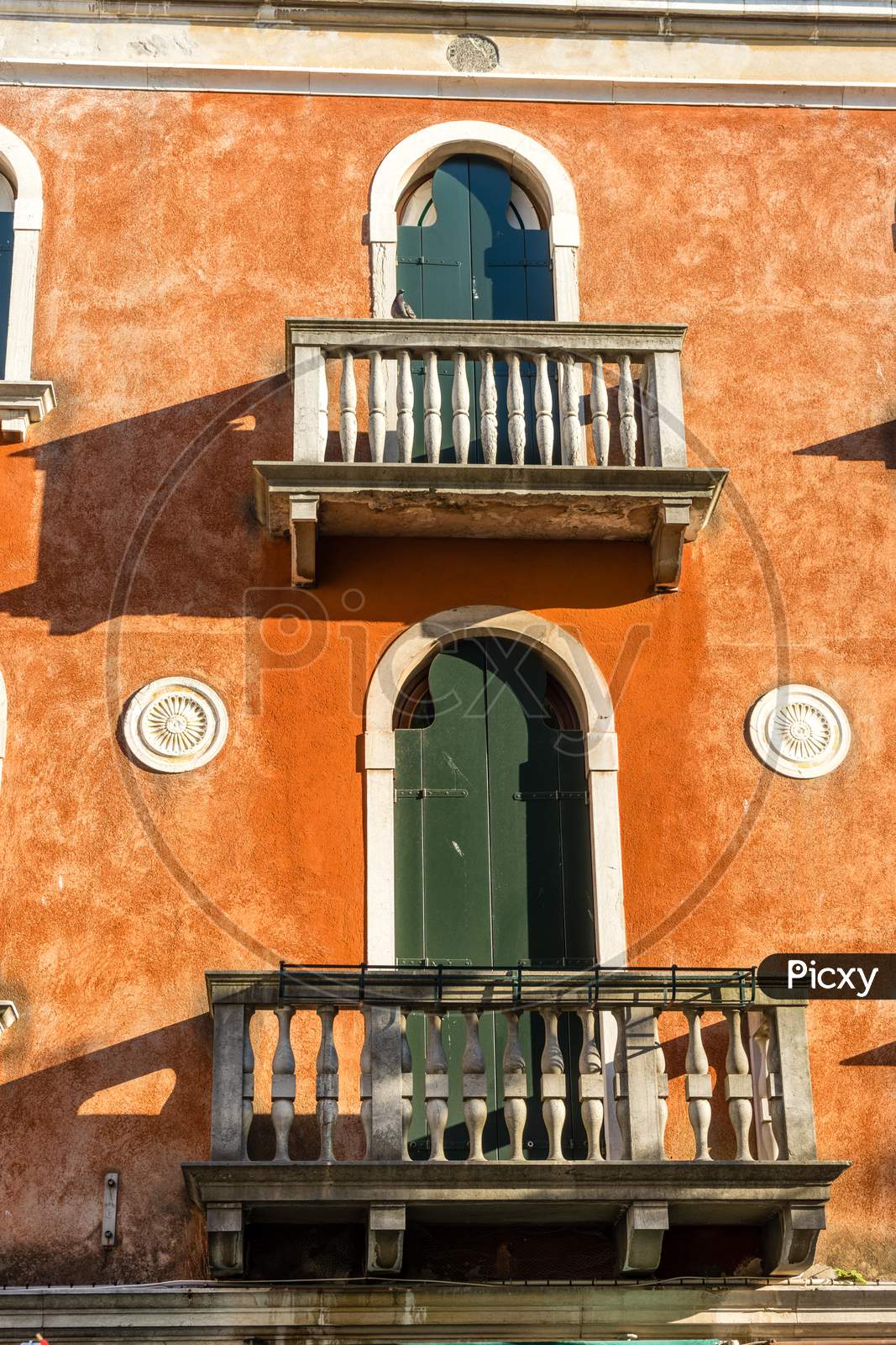 Italy, Venice, A Bench In Front Of A Brick Building