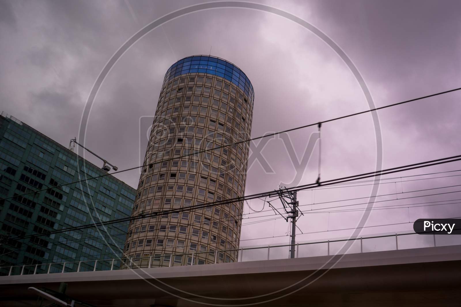 Den Haag, 22 June 2018: The Tall Cylindrical Shaped Residential Building Called Witte Anna By Emporis Viewed From Den Haag Central Railway Station