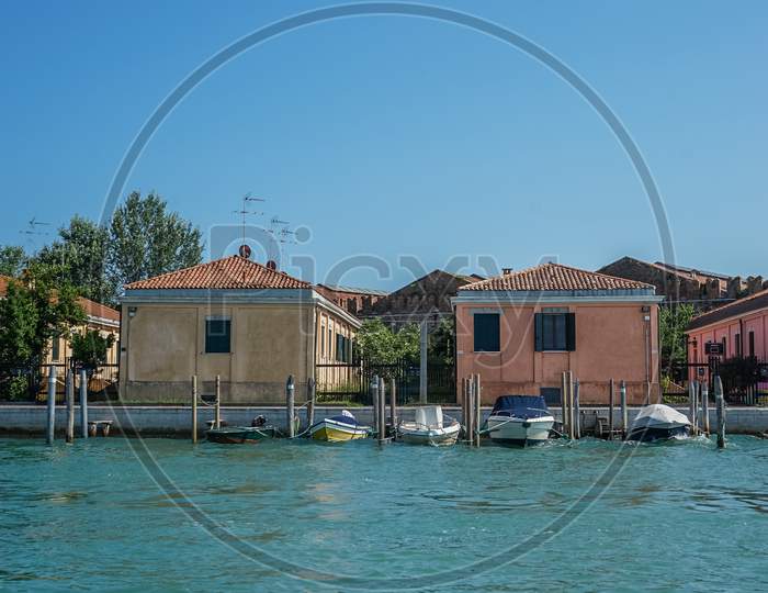 Italy, Venice, A Large Pool Of Water In Front Of A House