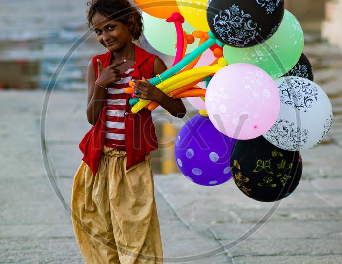 A little girl selling balloon on Varanasi ghats