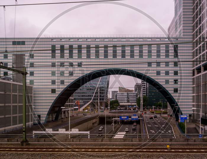 Den Haag, 22 June 2018: The Nn Investment Partners Building With An Arch And Road Below Viewed From Den Haag Central Railway Station