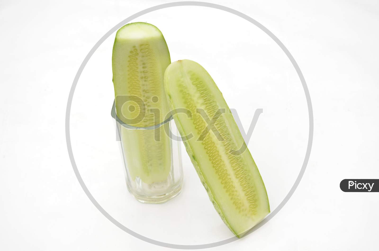 Sliced Cucumber In The Glass With Cucumber Isolated On White Background.