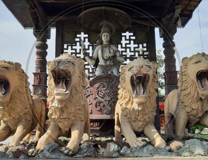 Durga maa on loins, old historical statue looking beautiful and attractive.