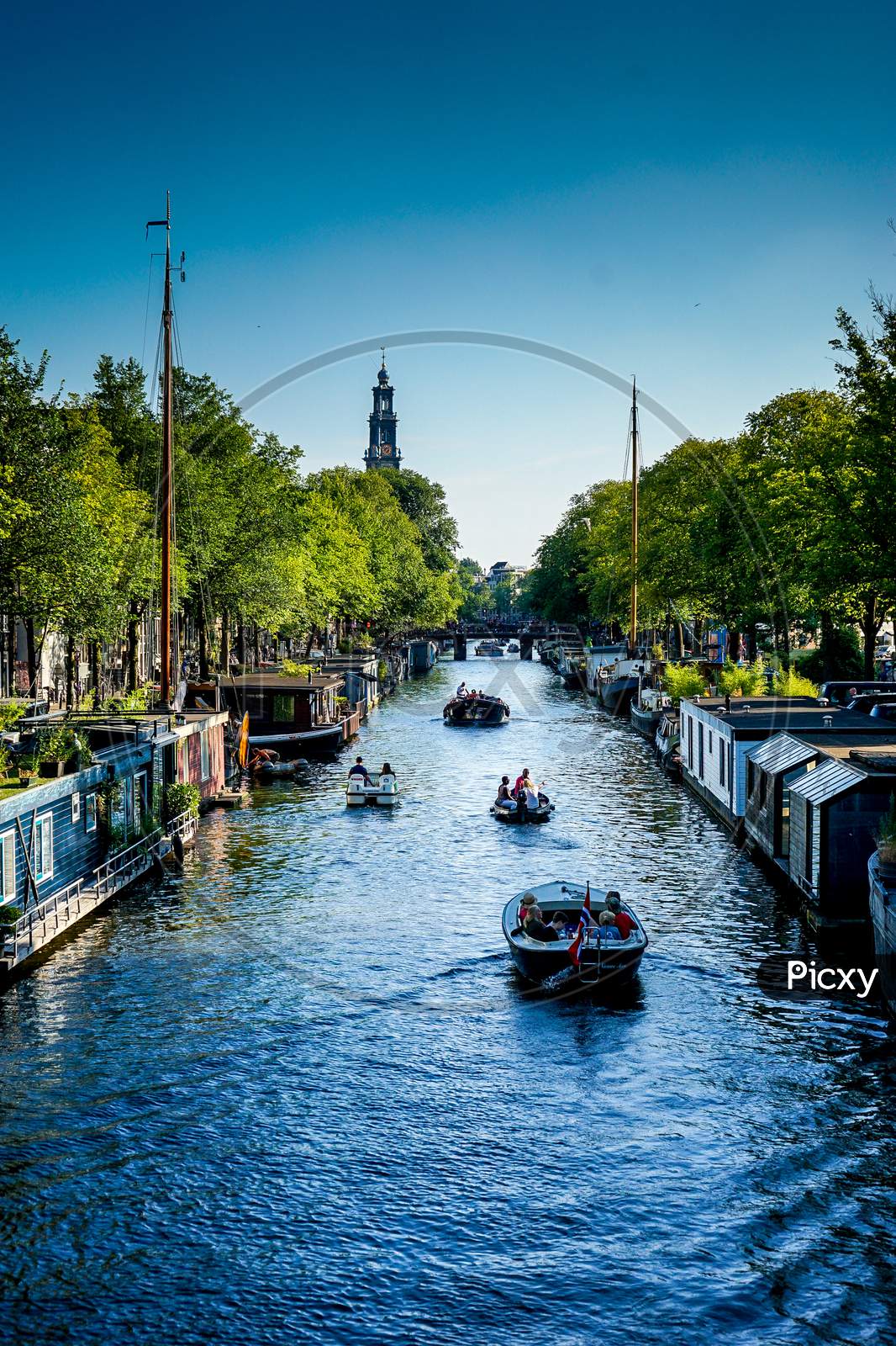 Netherlands, South Holland, Hampshire Inn - Prinsengracht, Canal Amidst Buildings Against Clear Sky