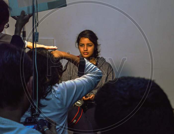 A Student Posing Like Sitter, Model At Classroom For Portfolio.