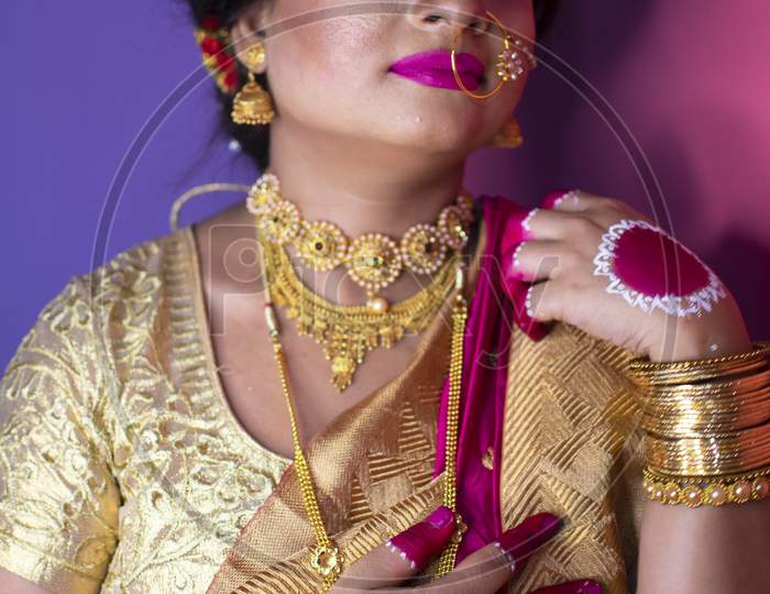 Indian Bride Dressed In Hindu Red Traditional Wedding Clothes Sari Embroidered With Gold Jewelry