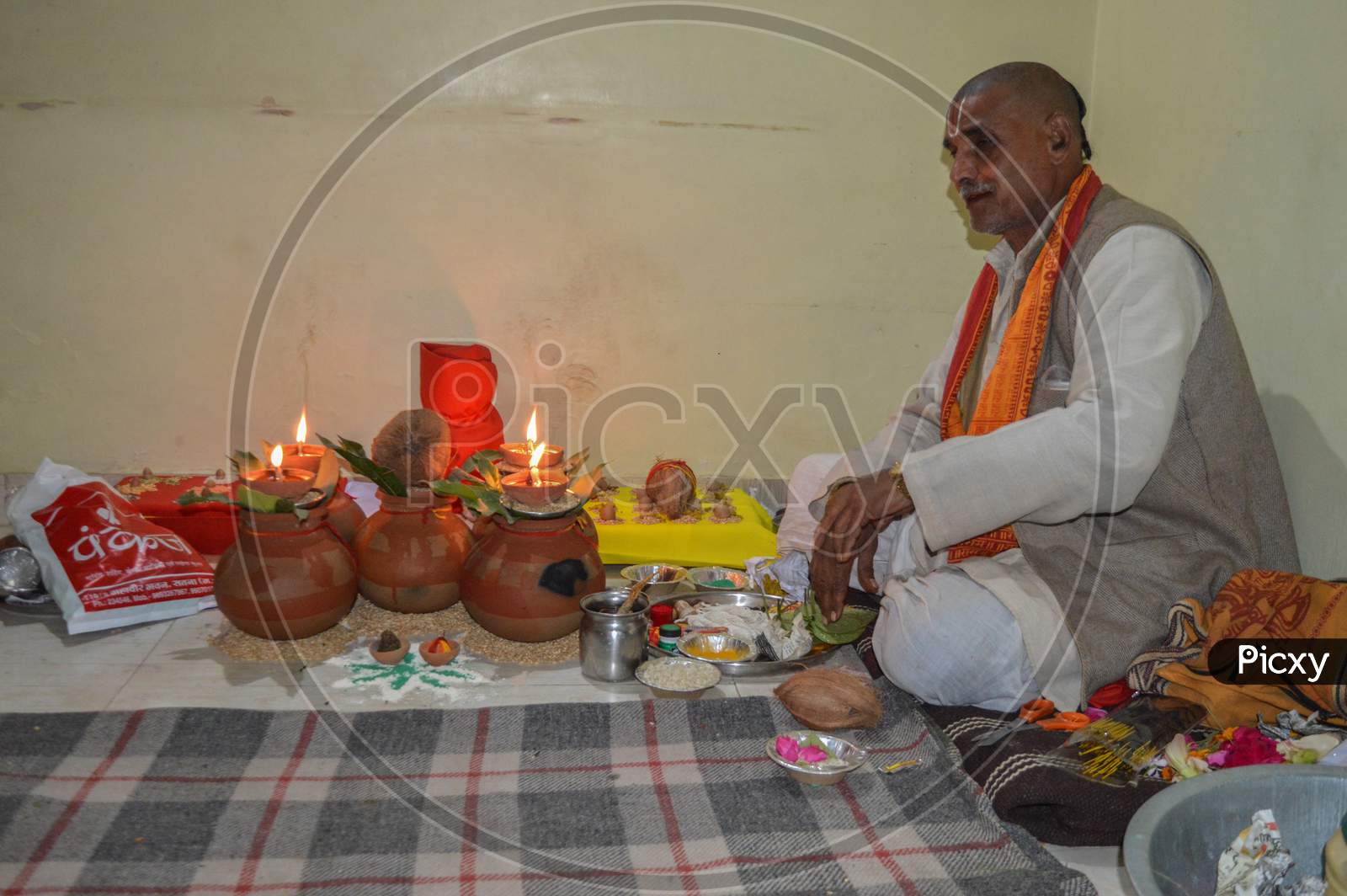 A Man Pujari Arranging Things Before Worship Of God.