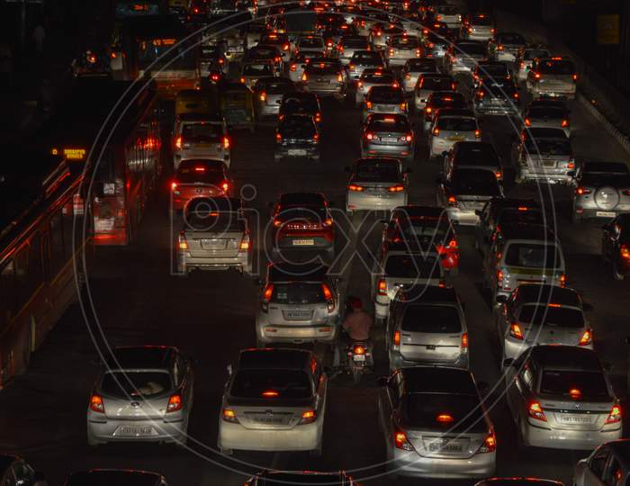 A Night Life View Of Polluted City, Which Is Jammed Because Of Huge Traffic On Road.