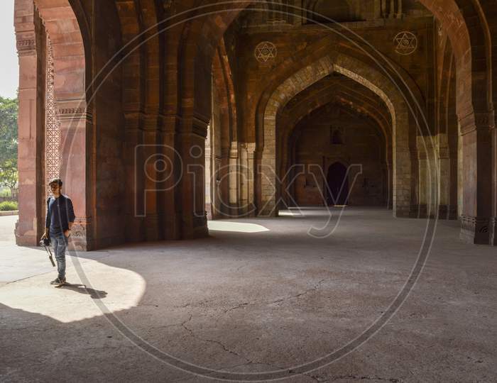 A Indian Boy Giving Pose For Fashion Shoot Inside Of Old Fort.