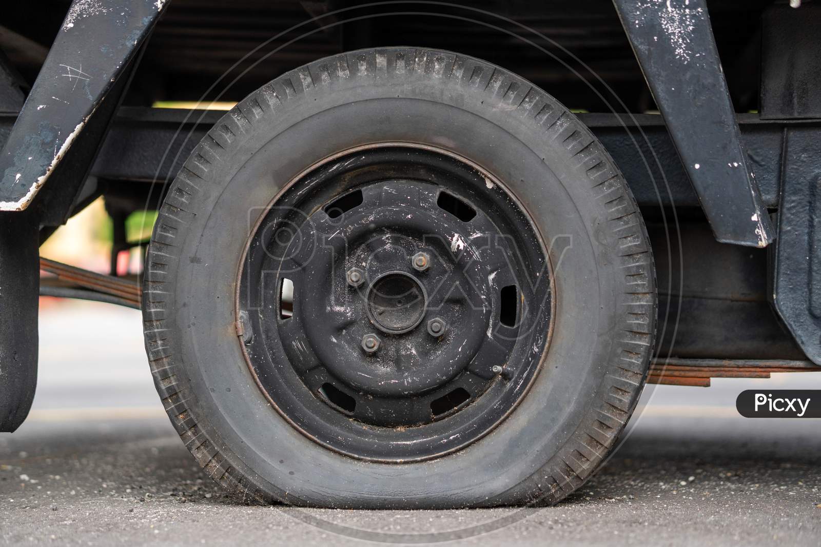 Closeup Shot Of A Van With A Flat tyre
