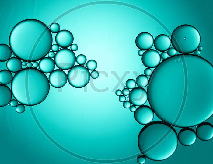 Colorful Oil Drops On A Cyan Background Water Surface