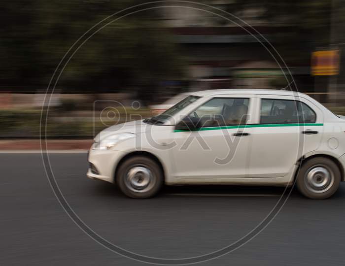 Panning Technique Of White Car Which Is Going Somewhere At Evening On The Road