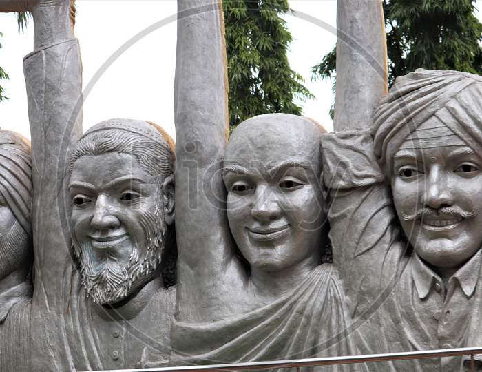 Statue of four men faces