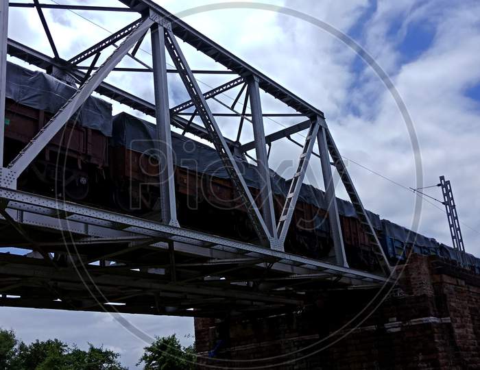 Railway Goods Train Going On Iron Bridge.