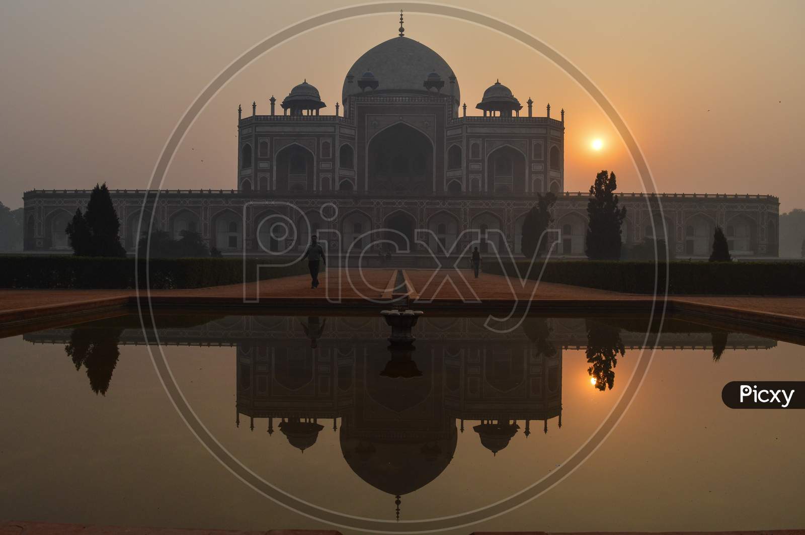A Reflection In Water And Mesmerizing View Of Humayun Tomb Memorial From The Main Gate,Entrance At Winter Foggy Morning.