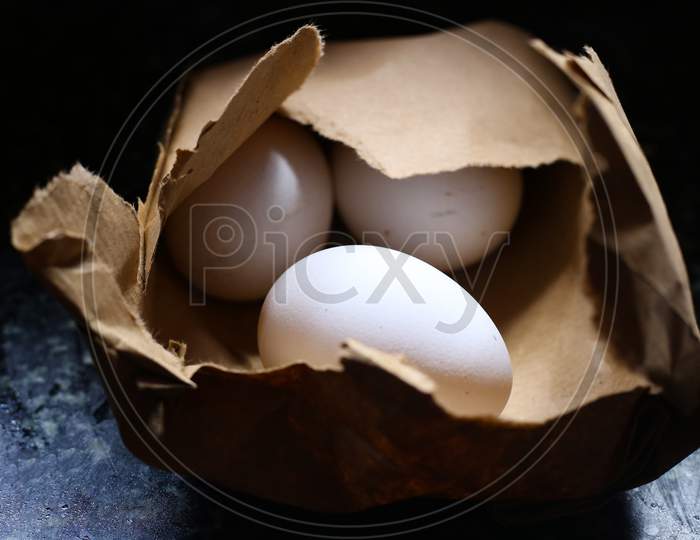 White Colour Chicken Egg In A Brown Cover