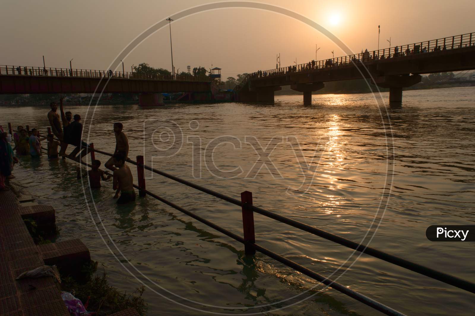 Many Boys Going To Jump Into Ganga River For Relief Of Heat In Summer At Sunrise At Haridwar Bridge Temple Sky.