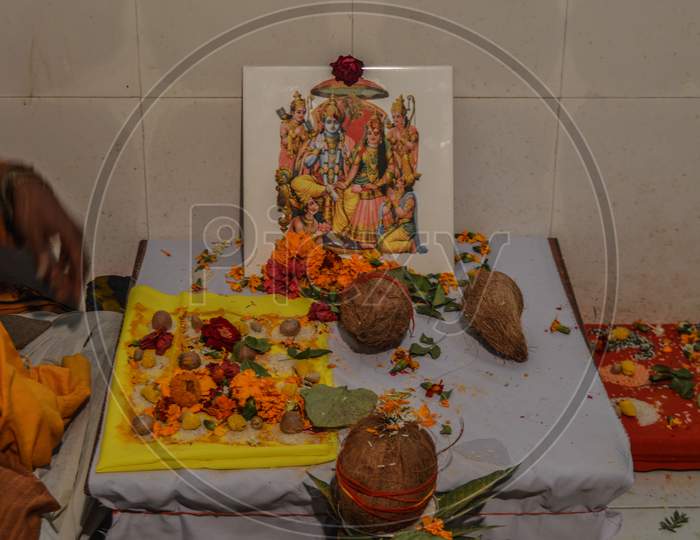 Statue Of Indian God With Coconut, Betel Nut, Rose.