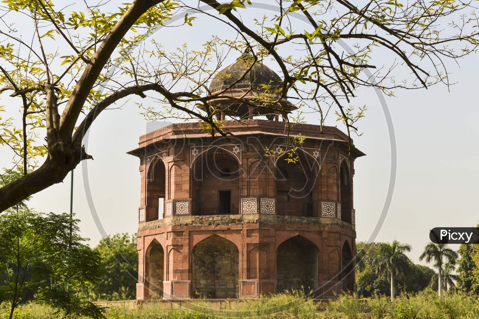 A Mesmerizing View Of Architecture Of Small Tomb At Old Fort From Side Lawn.