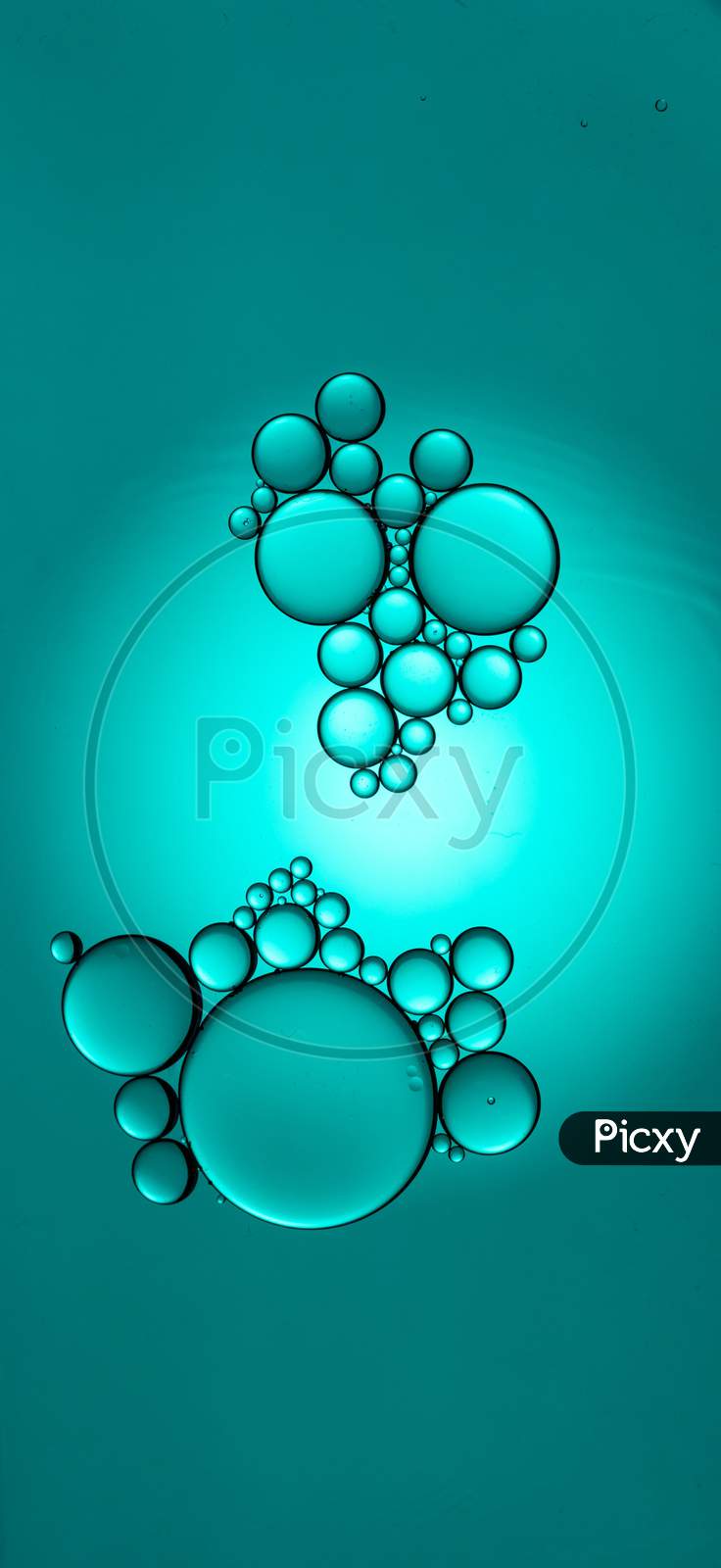 Portrait Of Colorful Oil Drops On A Cyan Background Water Surface