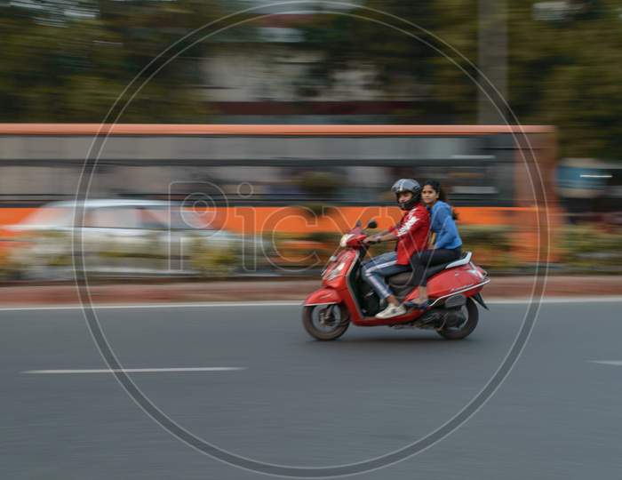Panning Technique Of Red Bike Going Somewhere At Evening On The Road