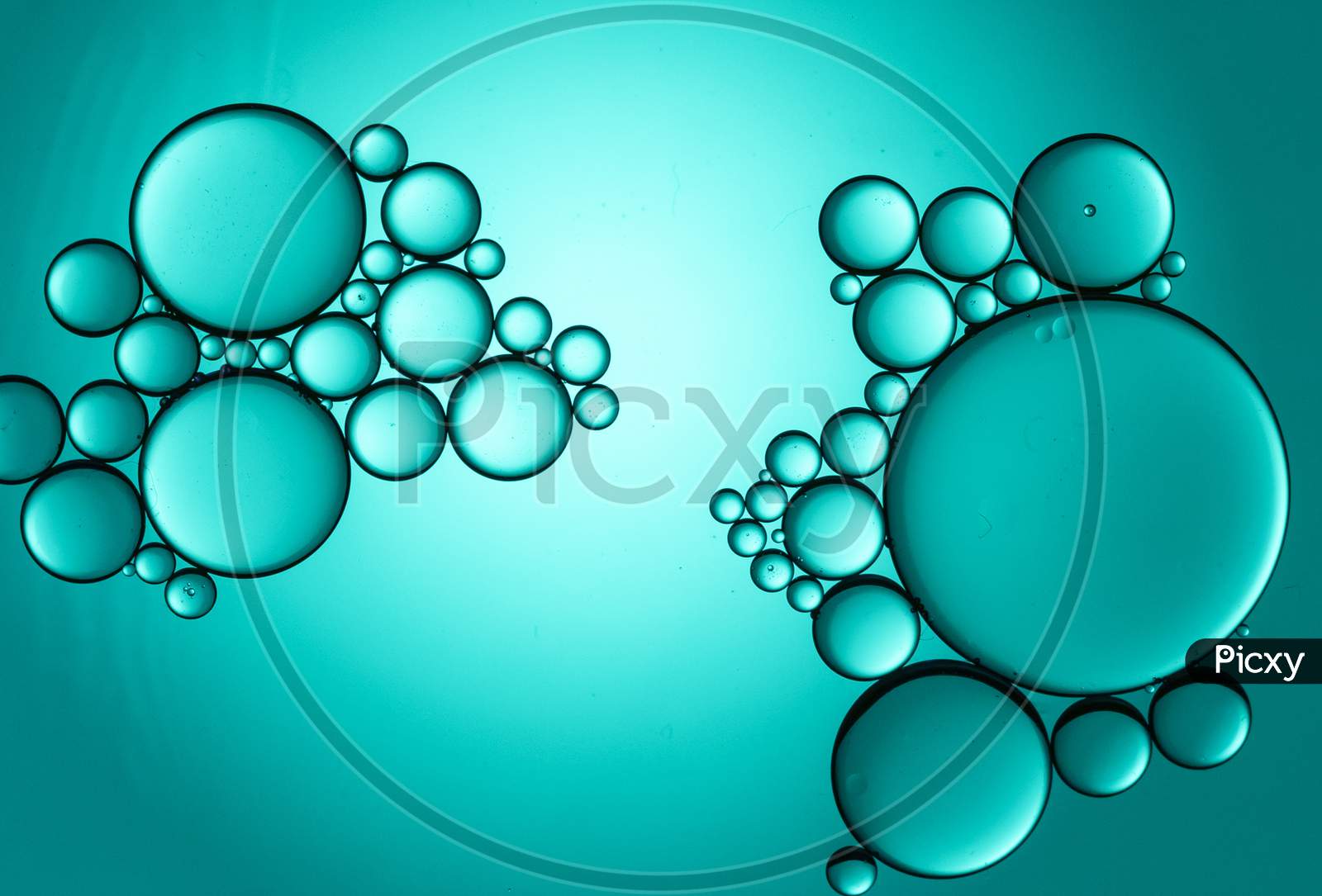 Colorful Oil Drops On A Cyan Background Water Surface