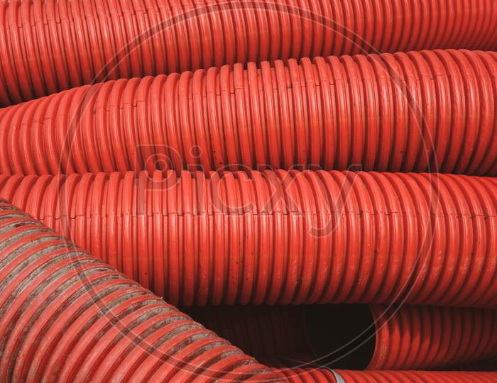 Huge Plastic Tubes In Red Lying Around