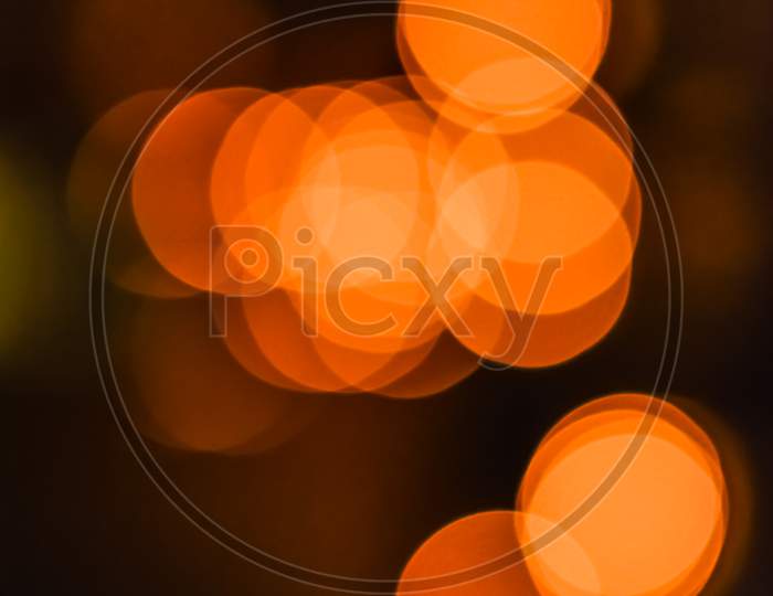 Portrait View Of Out Of Focus Yellow, Orange Light Bokeh Wallpaper Or Background For Texts, Images And Articles, Blank Space With Blurred Background.Large Golden Bokeh.