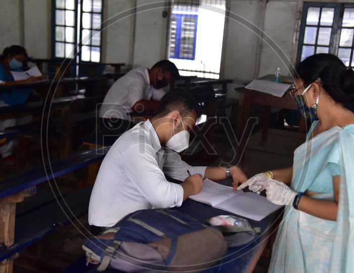 Students maintain social distancing as they attend a class after schools and colleges reopened after more than 5-months closure due to the Covid-19 coronavirus pandemic in  Nagaon District of Assam on Sep 21,2020.