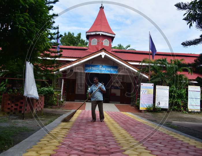 A man cleans a school campus  after schools and colleges re-opened in Assam during Unlock 4, in  Nagaon district of Assam on sep 21,2020