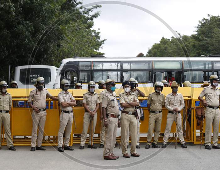 Police personnel stand guard during a farmers protest against the passage of two controversial farm bills by the country’s parliament in Bangalore, India.