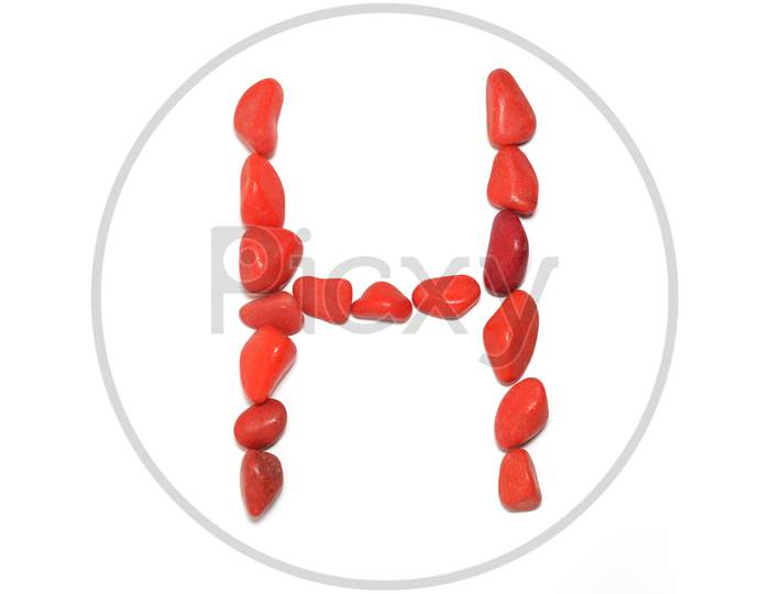 Alphabet In Red Pebbles On White Background
