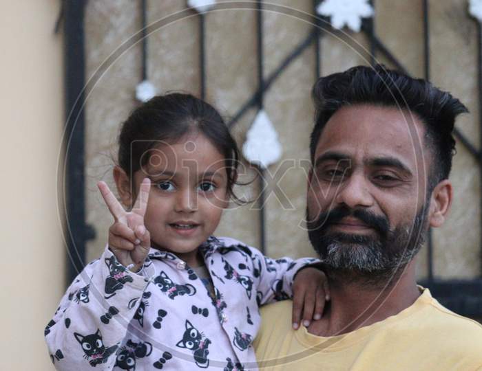 Cute punjabi baby and father photo in Punjab, India.