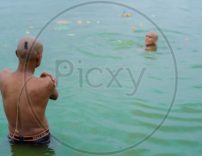 Hindu devotee taking bath in powai lake
