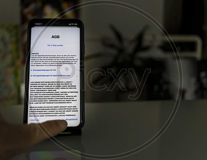 Frankfurt, Germany - September 17th 2020: A german photographer installing the all new iOS 14 software on his iPhone 11 Pro Max after the launch of the official version.