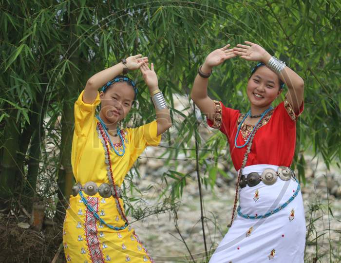 Two beautiful sisters from Arunachal Pradesh dancing beneath bamboo trees photo, Arunachal Pradesh, North East India.