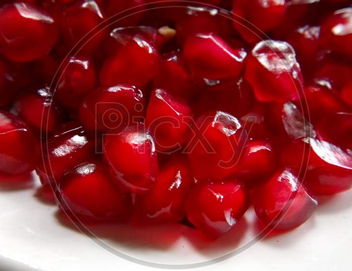Red pomegranate seeds in isolated white background,closeup picture