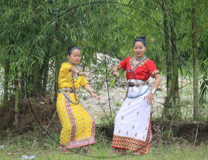 Beautiful Arunachalee girls dancing beneath bamboo trees photo in Arunachal Pradesh, North East India.