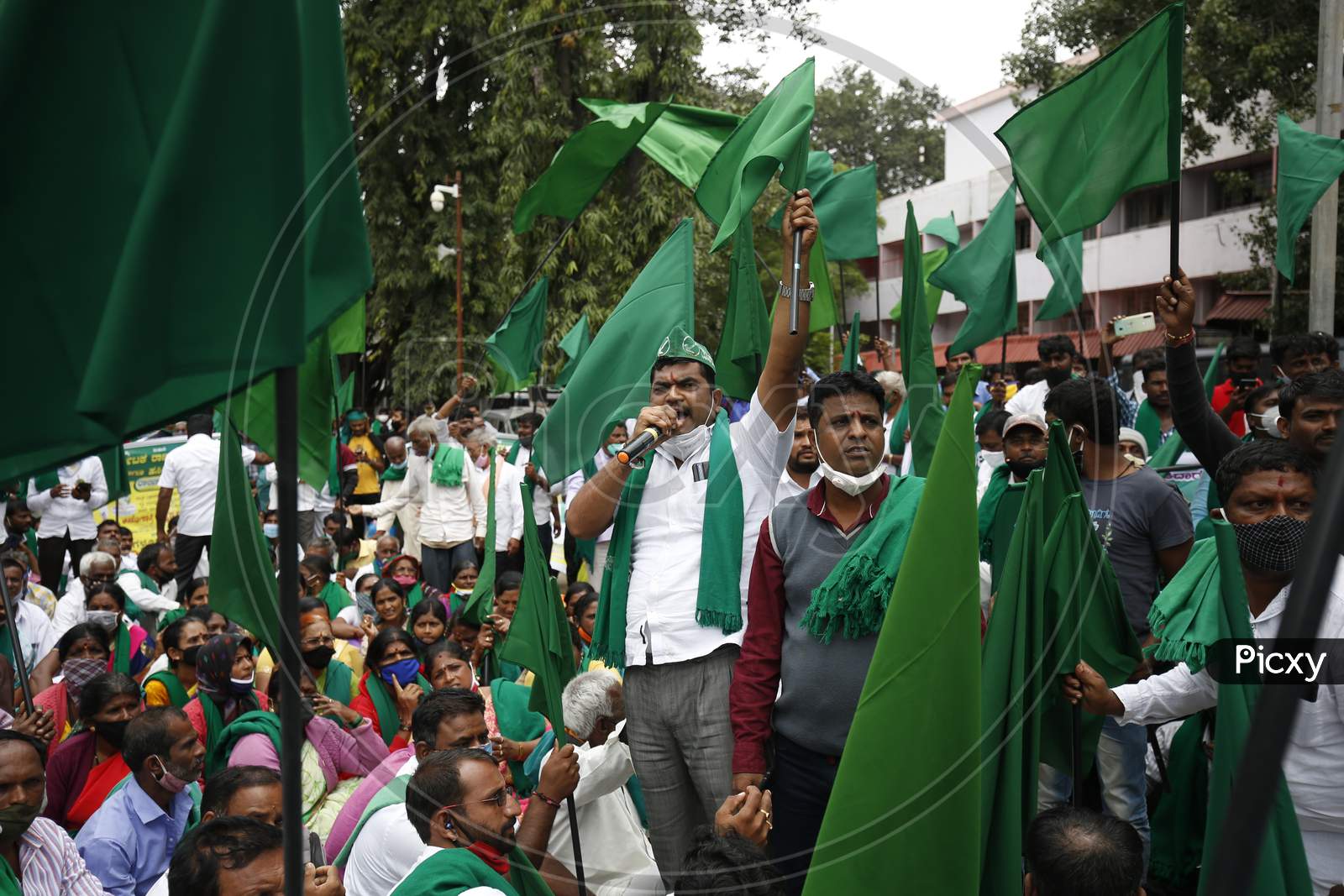 Farmers chant slogans against the government and wave flags during a protest against the passage of two controversial farm bills by the country’s parliament in Bangalore, India.