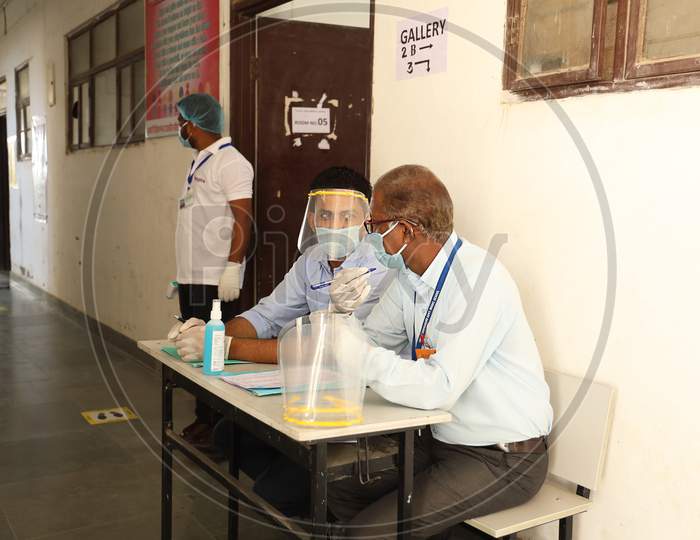 Jodhpur, Rajasthan, India, September 13,2020: Staff Wearing Face Shield And Mask Waiting For Students To Appear And Go Through Sanitation And Temperature Check Before Entering In School.