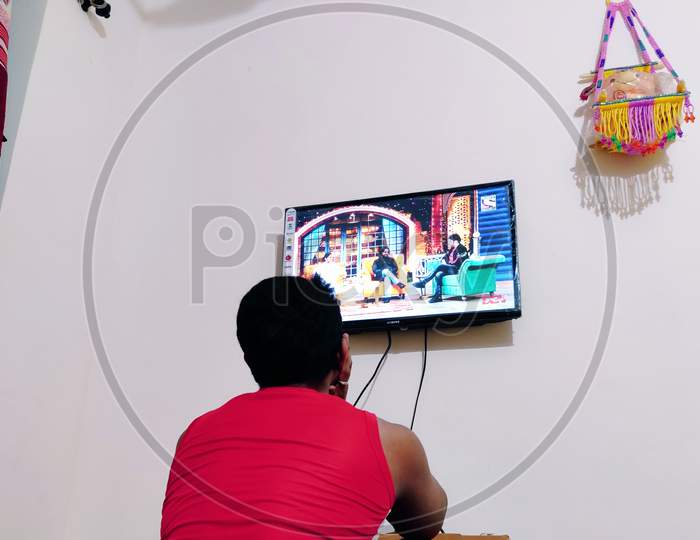 A man who is watching TV