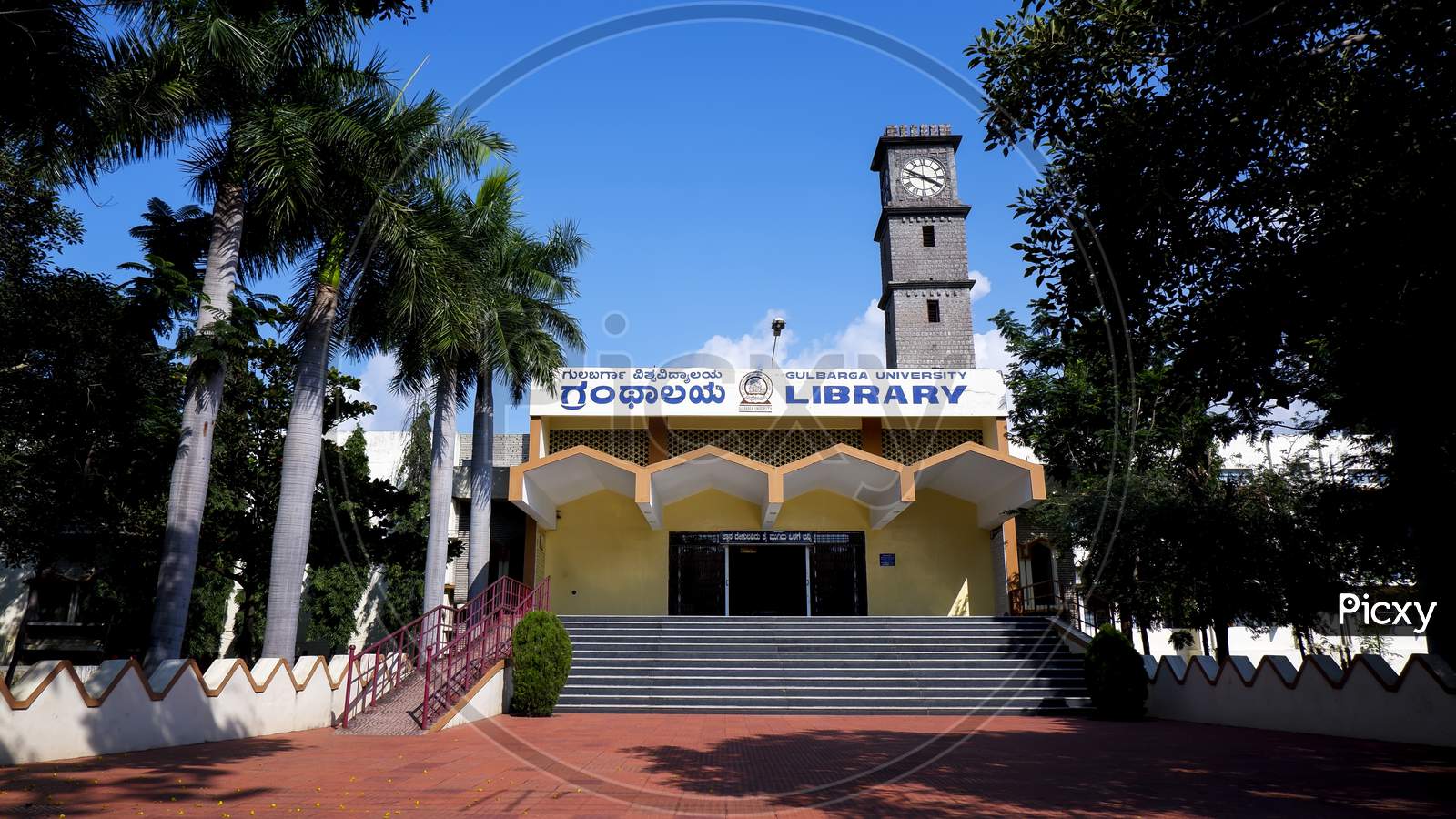 Kalaburagi, Karnalow Angle View Of Gulbarga University Library Building Isolated In Blue Sky