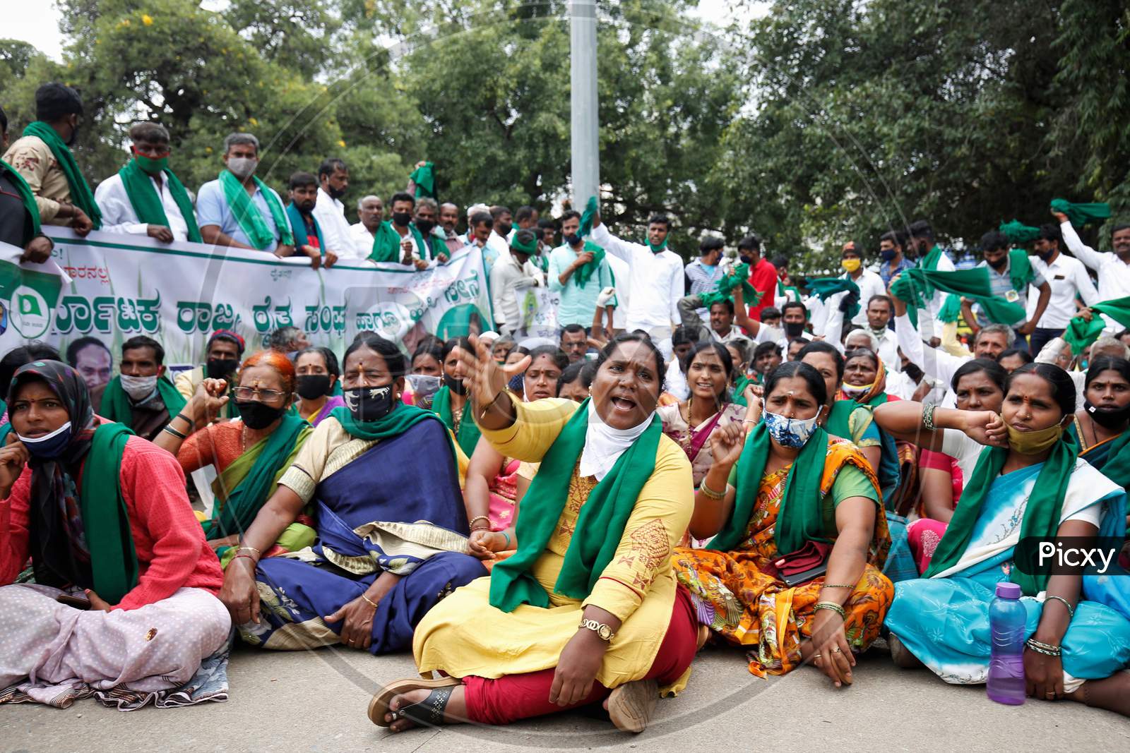 People chant slogans against the government and wave flags during a protest against the passage of two controversial farm bills by the country’s parliament in Bangalore, India.