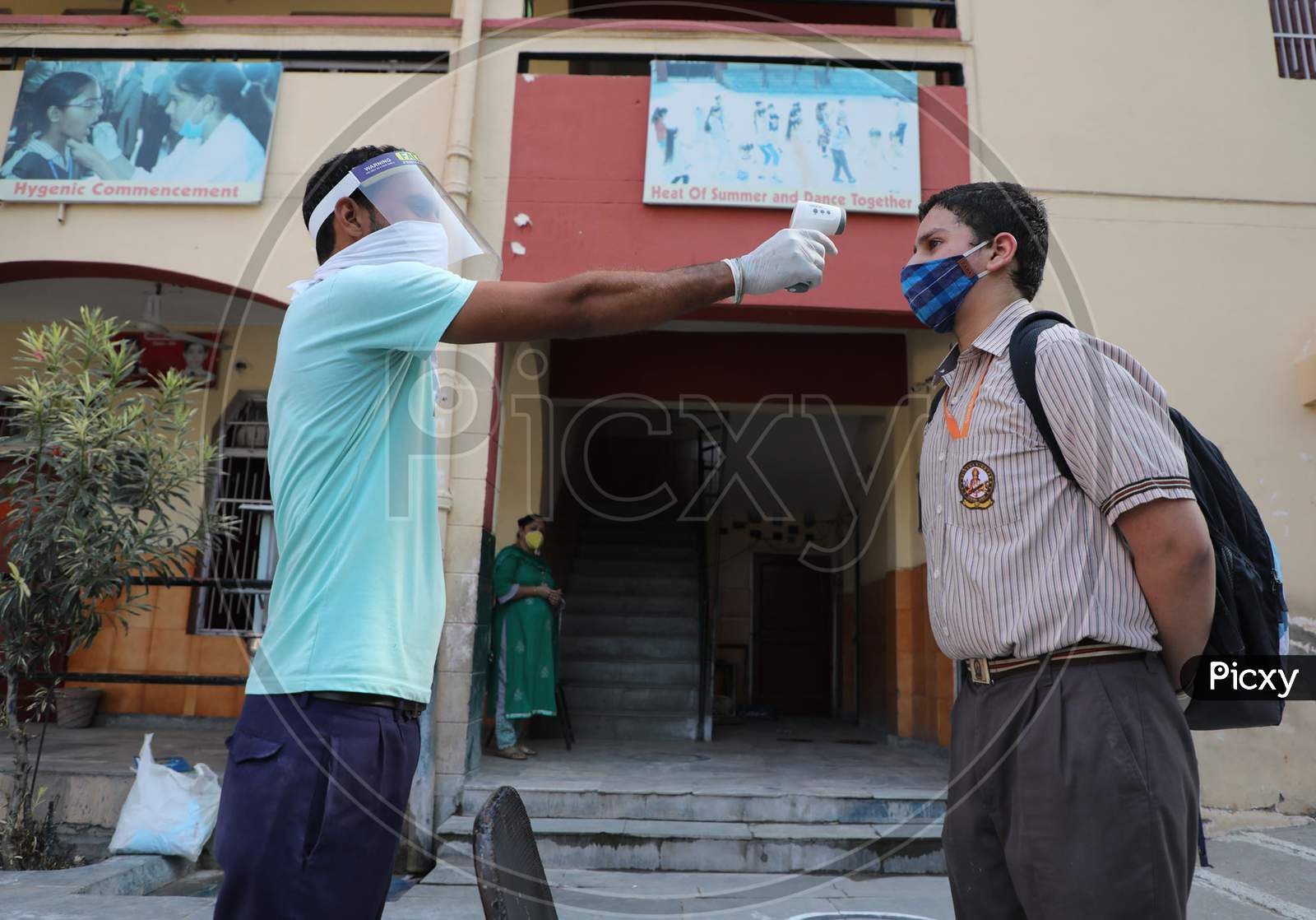 Students getting screened for fever at a school in Jammu on 21 September,2020. The schools across Jammu region partially reopened for 9th to 12th classes after six months closure due to the outbreak of Coronavirus pandemi .
