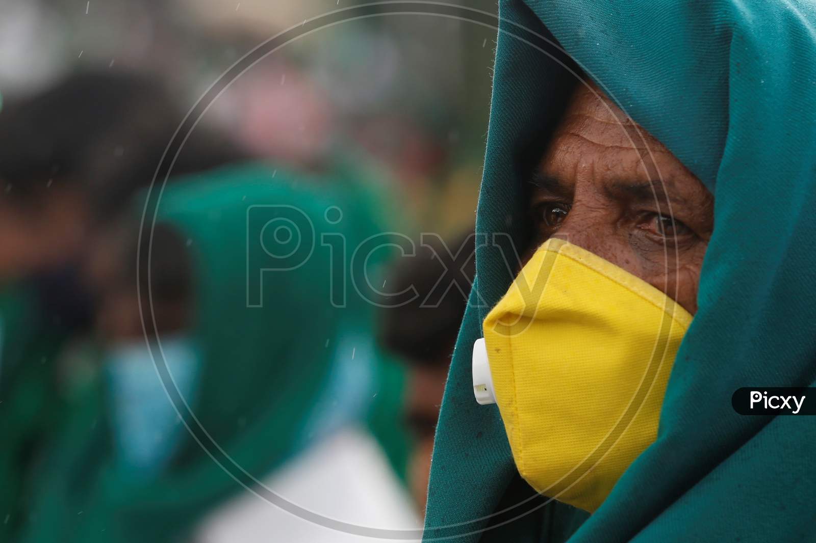 A farmer wears a mask and a face shield to protect from the novel coronavirus during a protest against the passage of two controversial farm bills by the country’s parliament in Bangalore, India.