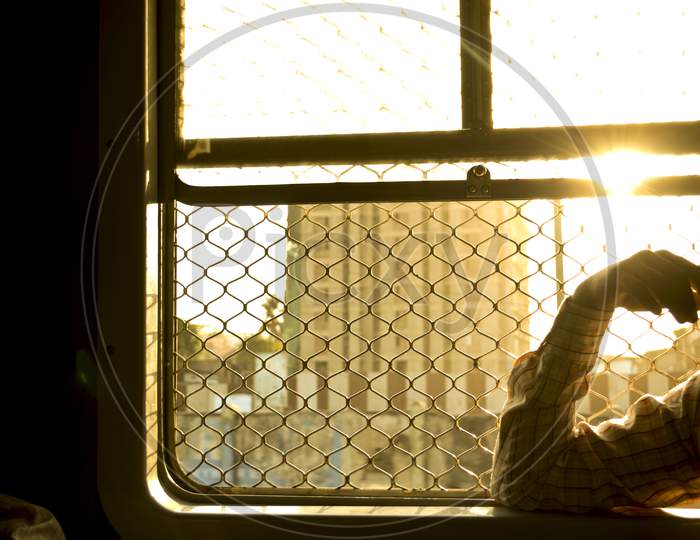 A Man Sitting Near Window In Mumbai'S Train