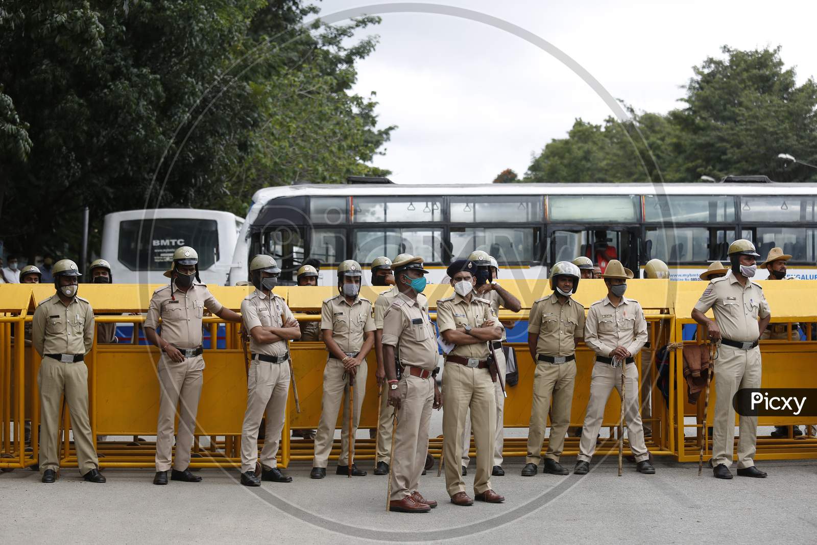 Police personnel stand guard during a farmers protest against the passage of two controversial farm bills by the country’s parliament in Bangalore, India.