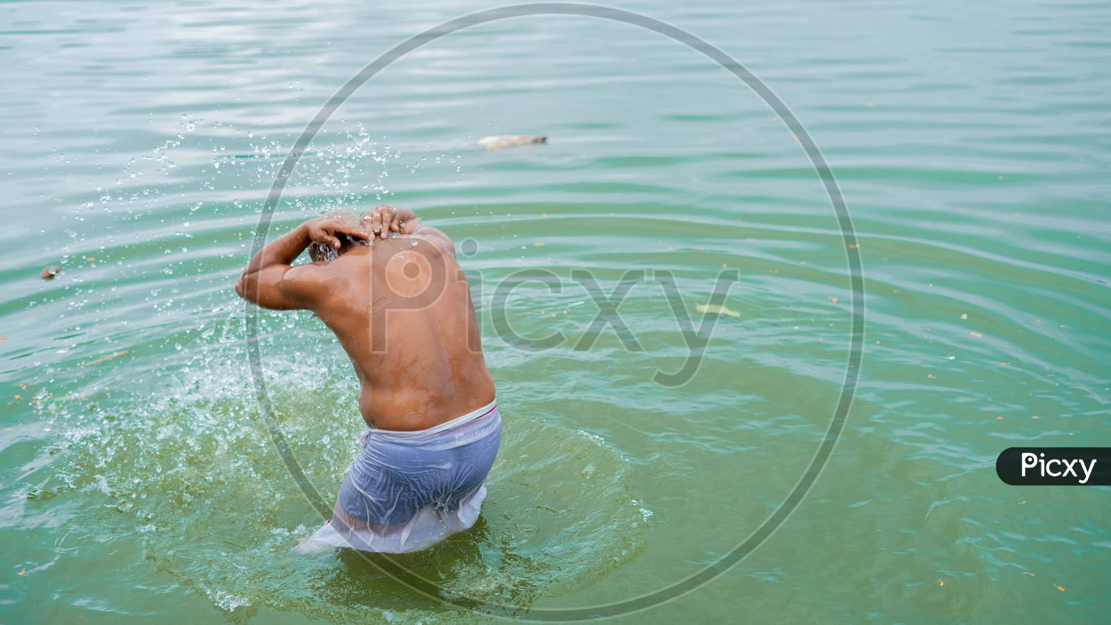 Devotee performing pooja on the bank of powai lake on ocassion of Pitru Pakshya 2020