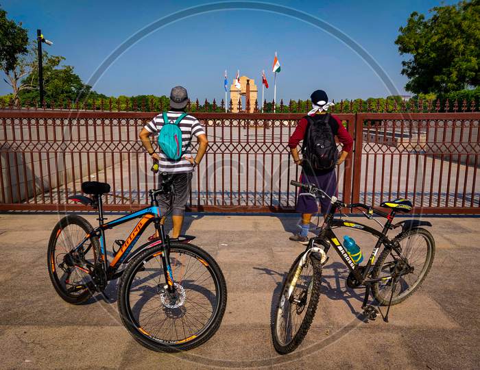 2 cyclists standing outside the National War Memorial, New Delhi, India