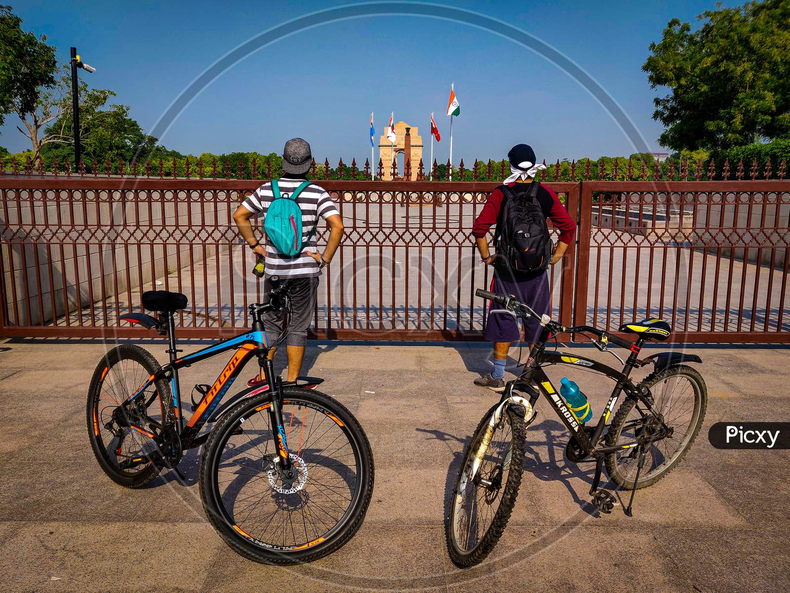 2 cyclists standing outside the National War Memorial, New Delhi, India
